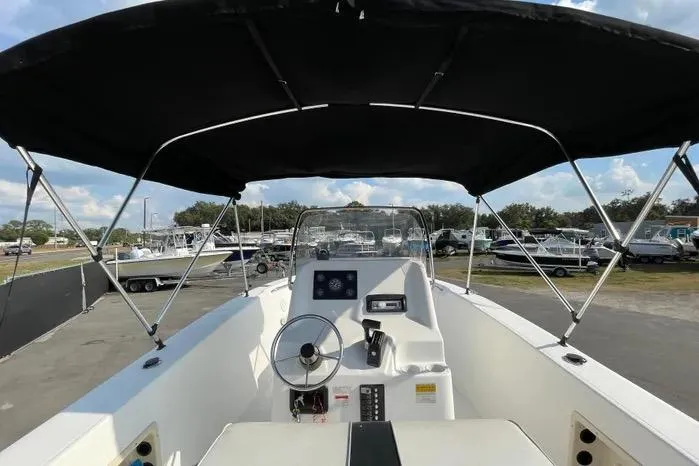 Slide: The Image of 2004 Kenner Fishmaster Travis Edition 220 boat interior with steering wheel and control panel. - 20