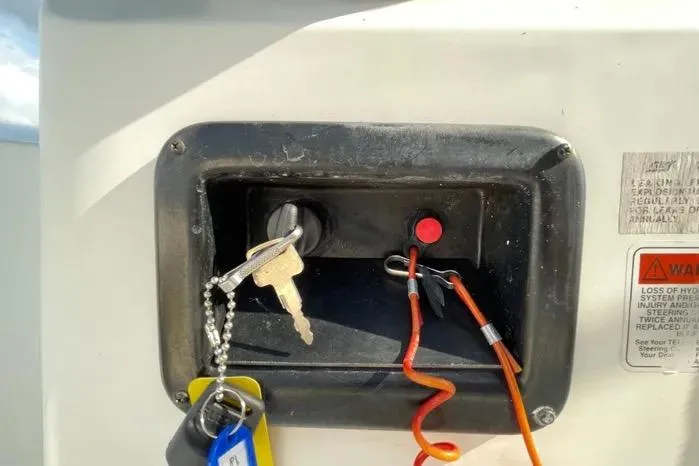 Slide: The Image of 2004 Kenner Fishmaster Travis Edition 220 boat interior with storage compartment and speaker. - 30