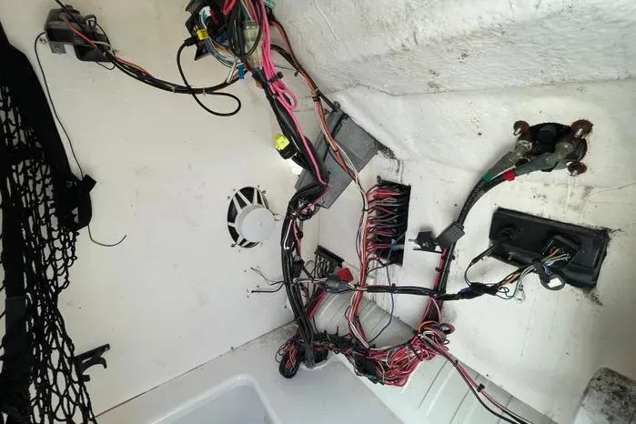 Slide: The Image of 2004 Kenner Fishmaster Travis Edition 220 boat interior with seating and cooler. - 34