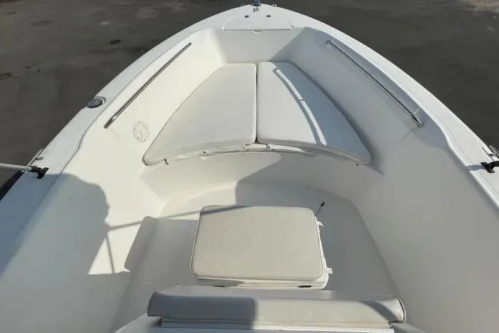 Slide: The Image of 2004 Kenner Fishmaster Travis Edition 220 boat interior with white cushioned seating. - 35