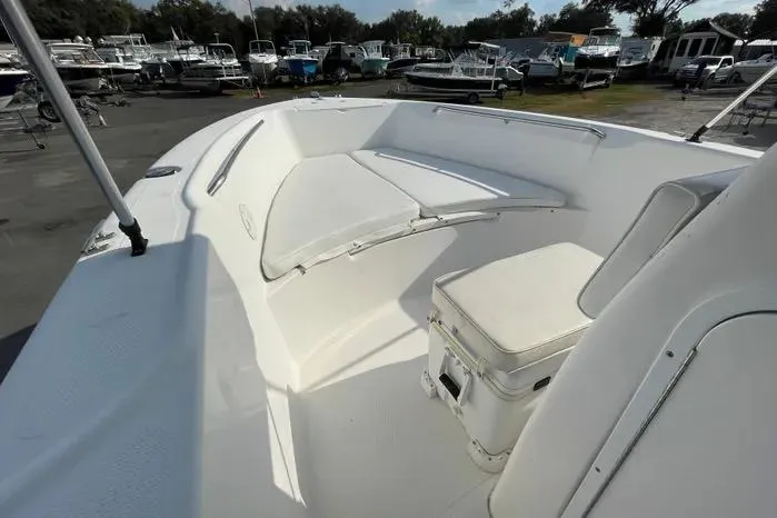 Slide: The Image of 2004 Kenner Fishmaster Travis Edition 220 boat interior with white cushioned seating. - 36