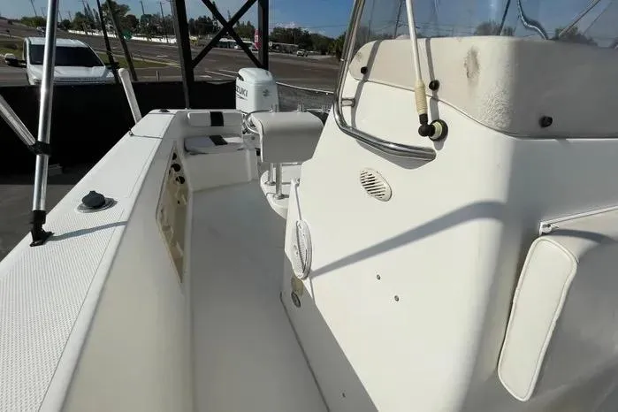 Slide: The Image of 2004 Kenner Fishmaster Travis Edition 220 boat interior with seating and motor. - 51