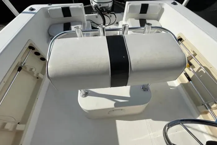 Slide: The Image of 2004 Kenner Fishmaster Travis Edition 220 boat interior with seating and motor. - 54