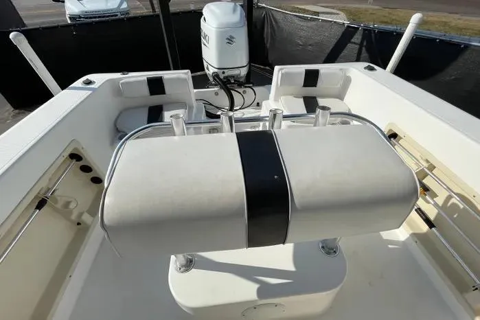 Slide: The Image of 2004 Kenner Fishmaster Travis Edition 220 boat interior with seating and steering wheel. - 55