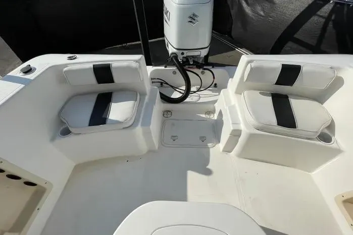 Slide: The Image of 2004 Kenner Fishmaster Travis Edition 220 boat seat with black and white upholstery. - 56