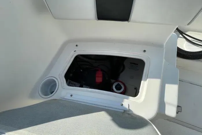 Slide: The Image of 2004 Kenner Fishmaster Travis Edition 220 boat seat with black and white upholstery. - 59