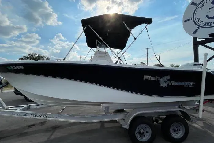 Slide: The Image of 2004 Kenner Fishmaster Travis Edition 220 boat on trailer with Suzuki outboard motor. - 6