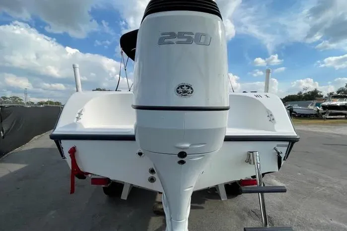 Slide: The Image of 2004 Kenner Fishmaster Travis Edition 220 boat on trailer, under a clear sky. - 8