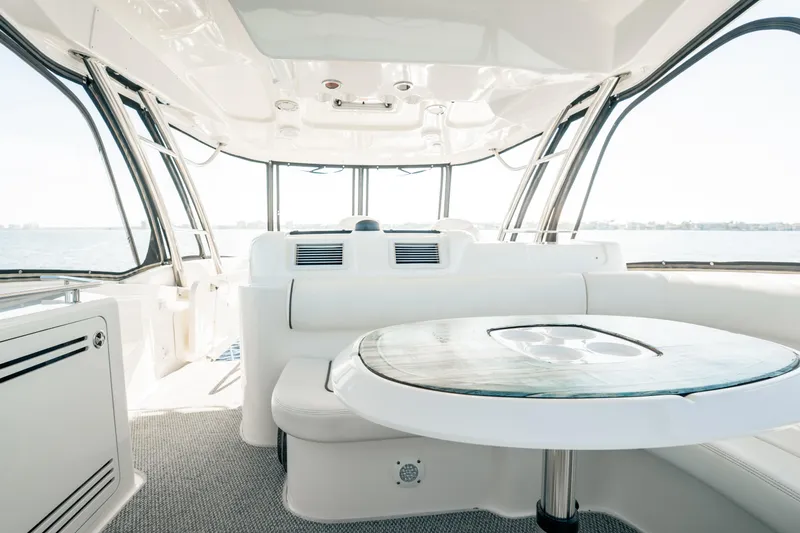 Slide: The Image of Interior of 2007 Sea Ray 580 Sedan Bridge yacht with elegant seating and table. - 14