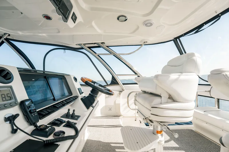 Slide: The Image of 2007 Sea Ray 580 Sedan Bridge helm with modern controls and luxurious seating. - 17