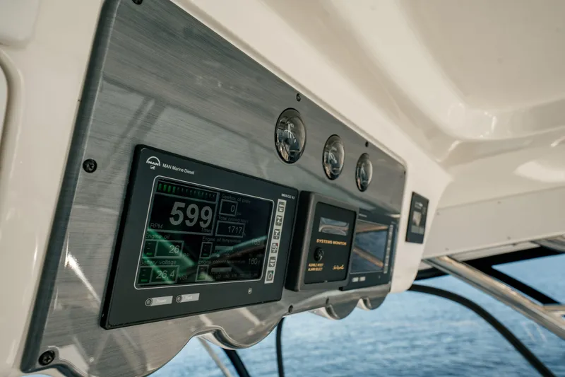 Slide: The Image of Control panel of 2007 Sea Ray 580 Sedan Bridge yacht, featuring digital displays and gauges. - 20