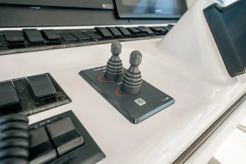 Slide: The Image of Control panel of 2007 Sea Ray 580 Sedan Bridge yacht with joysticks and buttons. - 21