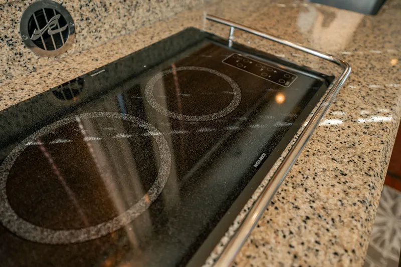 Slide: The Image of Granite countertop with electric cooktop on 2007 Sea Ray 580 Sedan Bridge yacht. - 22