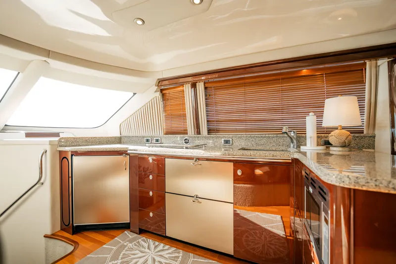 Slide: The Image of Luxurious kitchen interior of 2007 Sea Ray 580 Sedan Bridge yacht with modern amenities. - 31