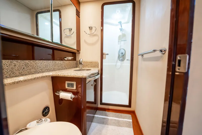 Slide: The Image of Luxurious bathroom in 2007 Sea Ray 580 Sedan Bridge yacht with granite countertop and shower. - 33
