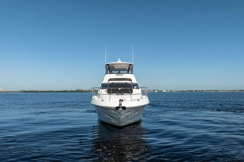 Slide: The Image of 2007 Sea Ray 580 Sedan Bridge yacht on calm blue water under clear sky. - 5