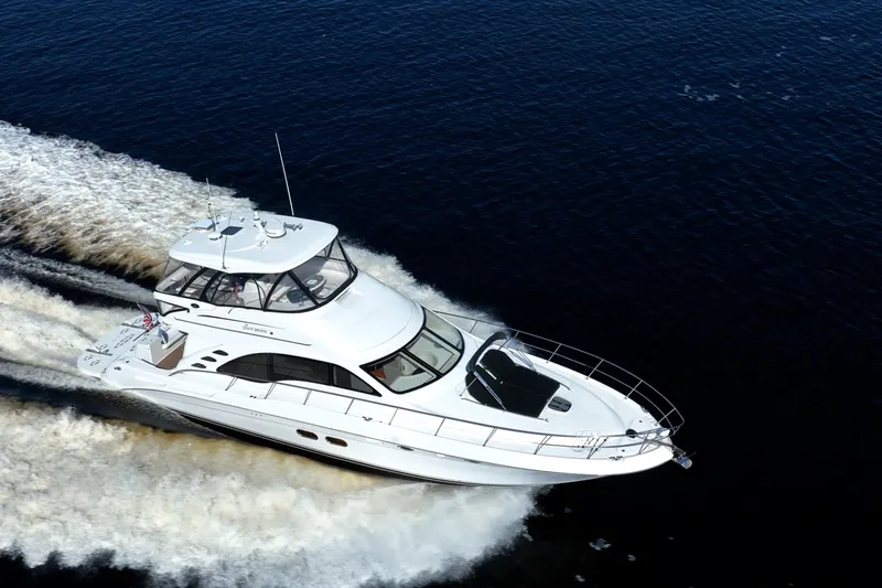 Slide: The Image of 2007 Sea Ray 580 Sedan Bridge yacht cruising on open water. - 7
