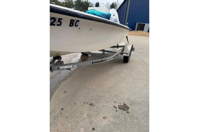 Slide: The Image of 1994 Chincoteague 16 boat on Load Rite trailer, parked on concrete surface. - 4
