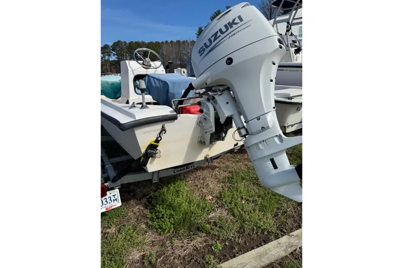 Slide: The Image of 1994 Chincoteague 16 boat with Suzuki outboard motor on trailer. - 7