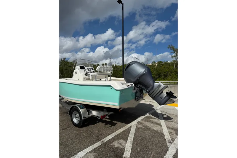 Slide: The Image of 2020 Tidewater 198 CC Adventure boat on trailer under cloudy sky. - 4