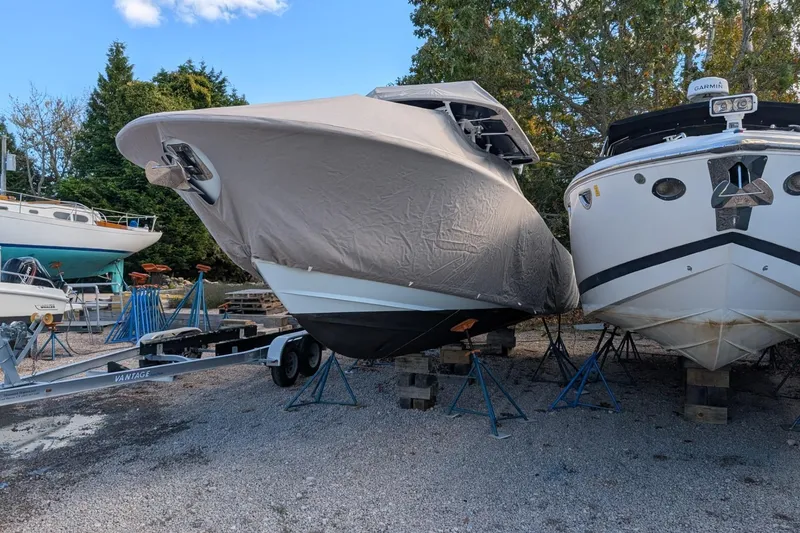 Slide: The Image of 2019 Southport 33 FE boat covered and stored on trailer, surrounded by other boats. - 18