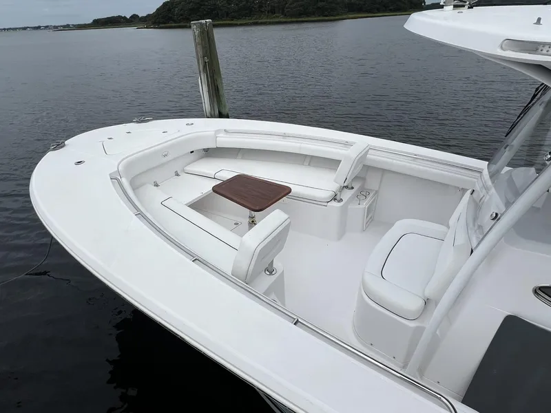 Slide: The Image of 2019 Southport 33 FE boat with spacious seating and table on calm water. - 3