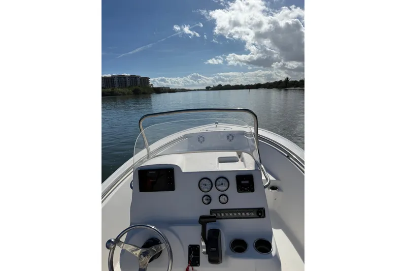 Slide: The Image of 2020 Tidewater 198 CC Adventure boat dashboard with scenic water view. - 6