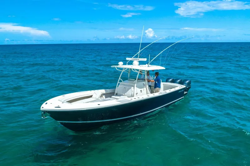 The Image of 2019 Regulator 34 boat on open ocean under clear blue sky. - 0