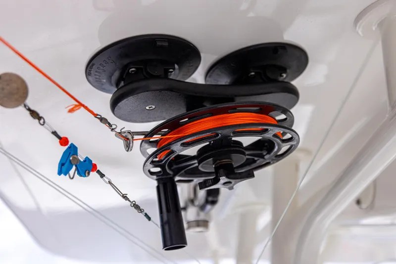 Slide: The Image of Fishing reel setup on 2019 Regulator 34 boat, featuring orange line and tackle. - 19