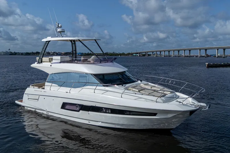 The Image of 2019 Prestige 460 yacht on calm water with bridge in background. - 0