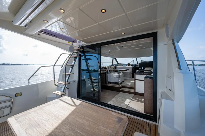 Slide: The Image of Luxury 2019 Prestige 460 yacht interior with open deck and ocean view. - 23