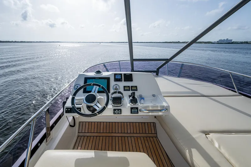 Slide: The Image of Prestige 460 yacht helm, 2019 model, with ocean view and modern controls. - 30