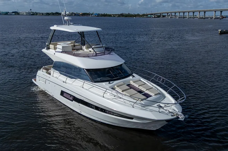 Slide: The Image of 2019 Prestige 460 yacht cruising on open water under a clear sky. - 4