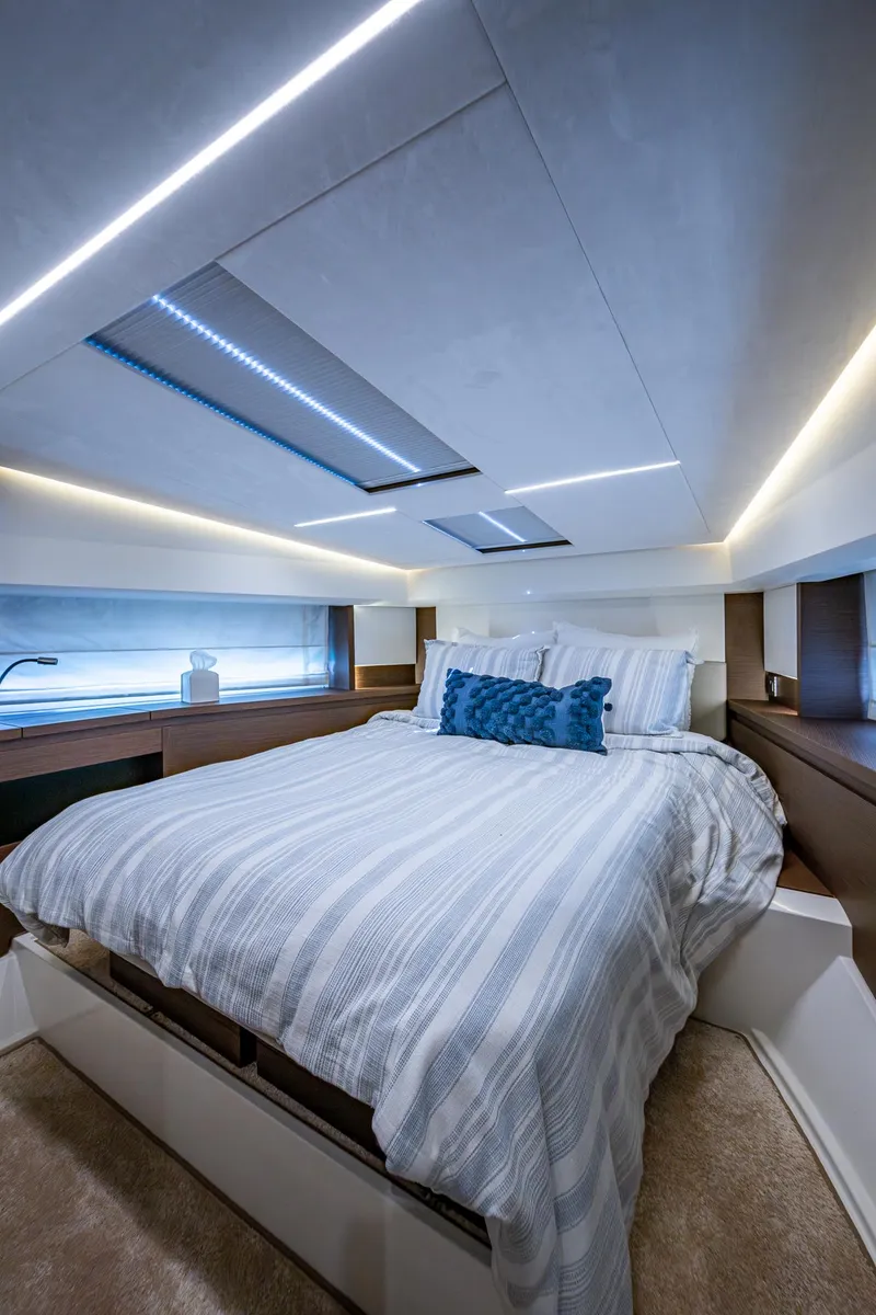 Slide: The Image of Luxurious bedroom interior of 2019 Prestige 460 yacht with modern lighting and cozy bedding. - 45