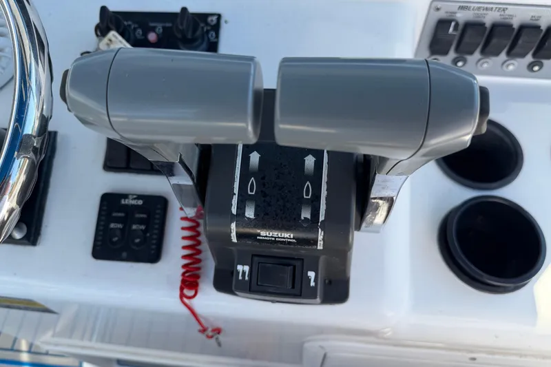 Slide: The Image of Control panel of a 2001 Bluewater 2350 CC boat with Suzuki throttle. - 13