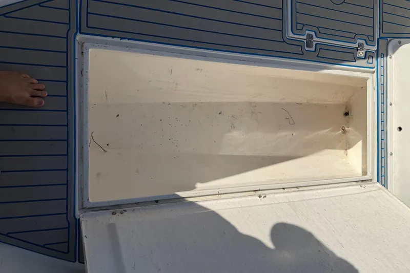 Slide: The Image of Open storage compartment on 2001 Bluewater 2350 CC boat deck. - 17