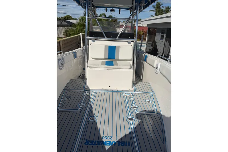 Slide: The Image of 2001 Bluewater 2350 CC boat interior with striped flooring and seating. - 18