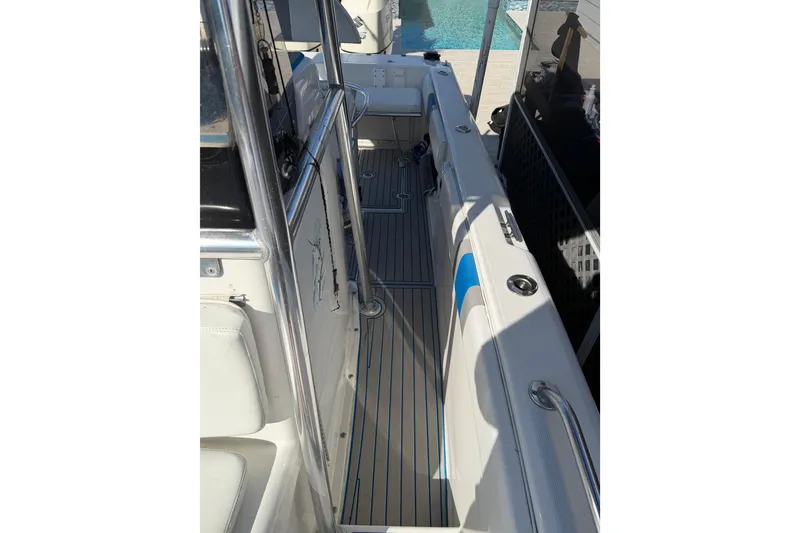 Slide: The Image of 2001 Bluewater 2350 CC boat interior with seating and stainless steel railings. - 19