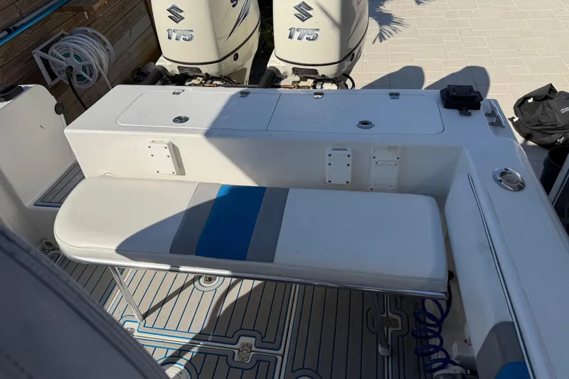 Slide: The Image of 2001 Bluewater 2350 CC boat interior with seating and dual Suzuki 175 engines. - 22