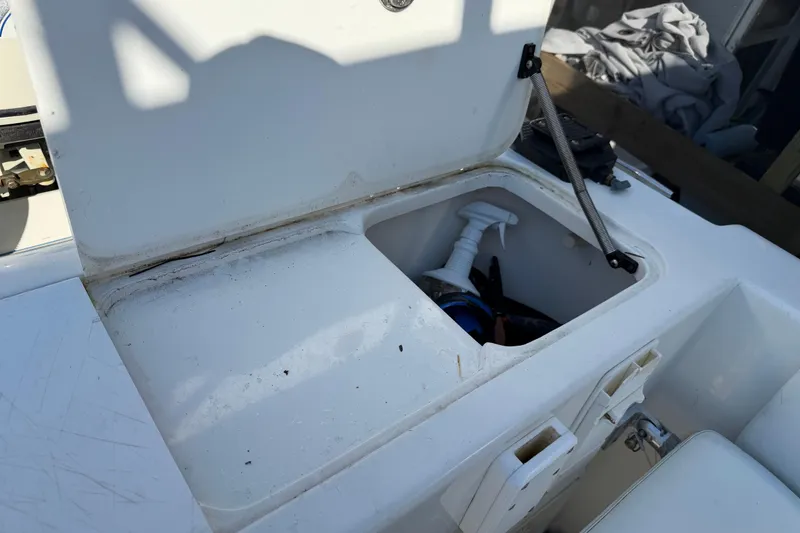 Slide: The Image of Open storage compartment on 2001 Bluewater 2350 CC boat, showing interior equipment. - 30