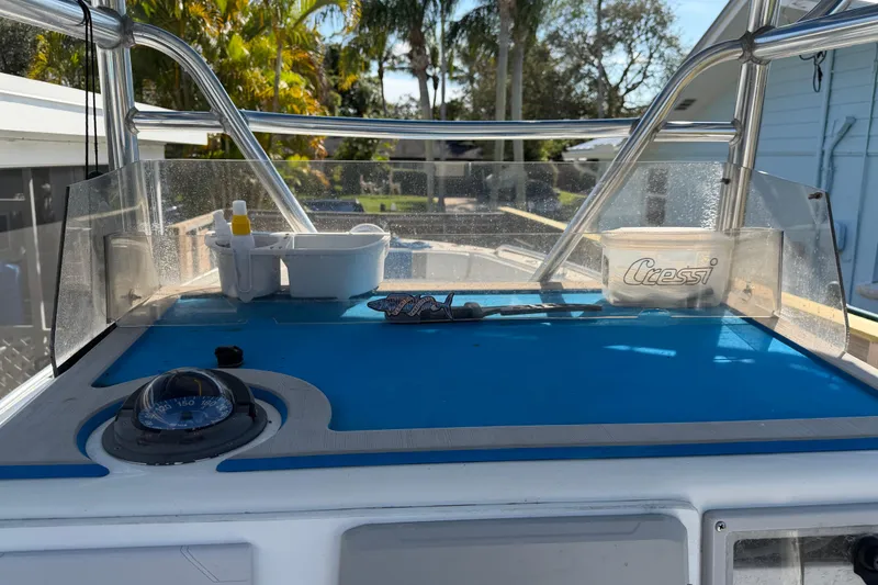 Slide: The Image of 2001 Bluewater 2350 CC boat dashboard with compass and Cressi container. - 36