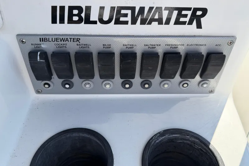 Slide: The Image of Control panel of a 2001 Bluewater 2350 CC boat with labeled switches. - 37