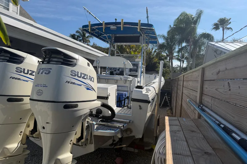 Slide: The Image of 2001 Bluewater 2350 CC boat with twin Suzuki 175 outboard engines, docked outdoors. - 5