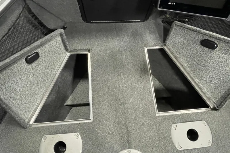 Slide: The Image of 2018 Lund 1875 Impact Sport boat interior with open storage compartments. - 18