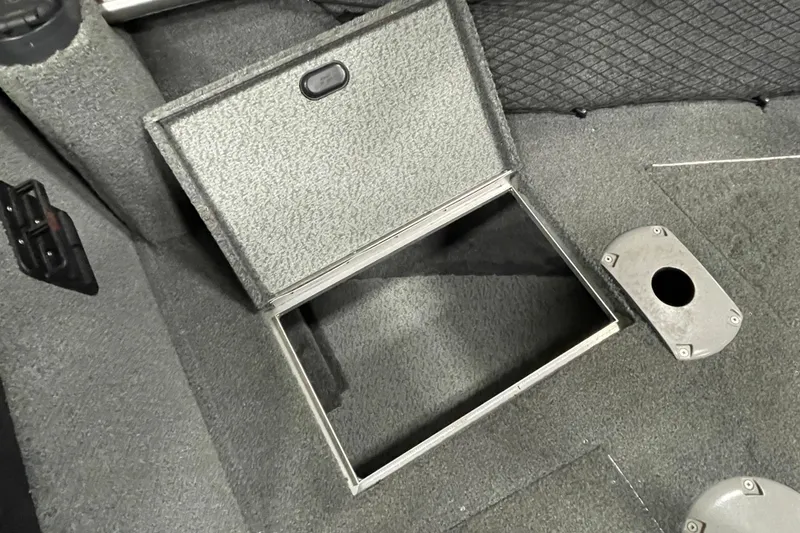 Slide: The Image of 2018 Lund 1875 Impact Sport boat interior storage compartment open. - 20