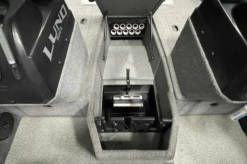 Slide: The Image of 2018 Lund 1875 Impact Sport boat interior with storage compartment and battery. - 21