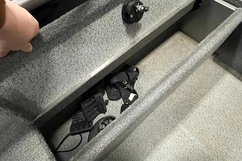 Slide: The Image of Interior of 2018 Lund 1875 Impact Sport boat showing storage compartment and accessories. - 22