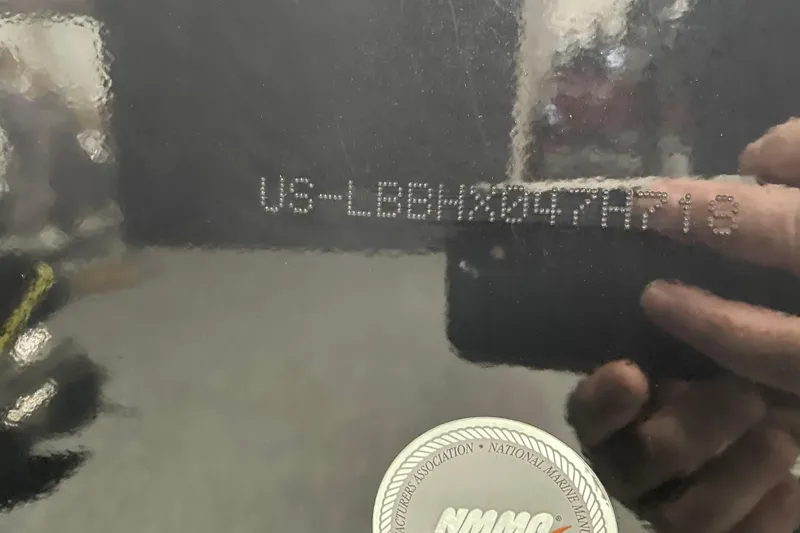 Slide: The Image of 2018 Lund 1875 Impact Sport boat hull identification number and NMMA certification sticker. - 24