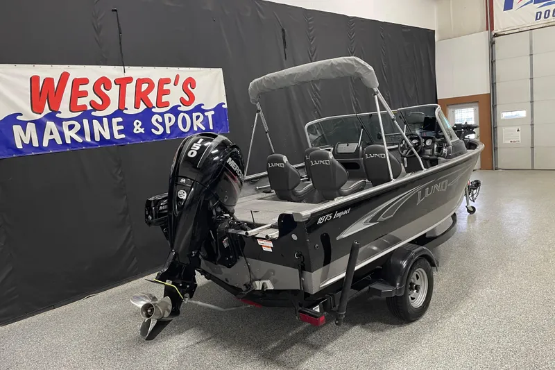 Slide: The Image of 2018 Lund 1875 Impact Sport boat displayed at Westre's Marine & Sport showroom. - 3