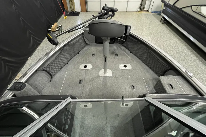 Slide: The Image of 2018 Lund 1875 Impact Sport boat interior with trolling motor and spacious deck. - 7